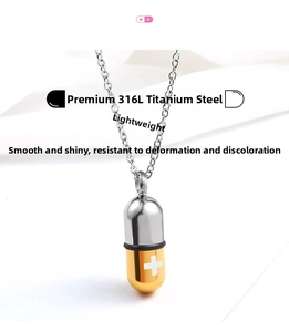 Macro detail of 316L stainless steel pill capsule pendant with gold finish and white cross