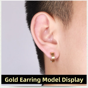 Close-up of gold stainless steel clip-on hoop earring worn by a male model