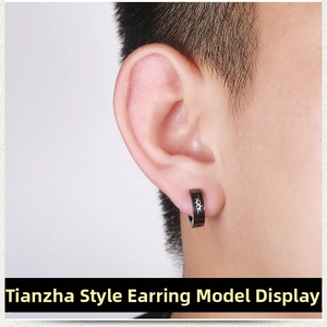 Close-up of black titanium steel ear clip for men featuring white tribal totem pattern