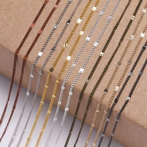 Macro shot of multi-color DIY metal chains in gold, silver, and bronze finishes