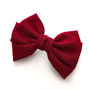 Wine red large fabric knotted bow hair clip with textured cotton linen finish on white background