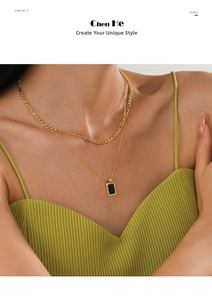 Close-up of double layer gold necklace with black square pendant on model's neck