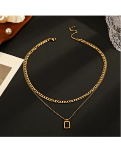 Close-up of double-layer stainless steel necklace with square black pendant and cuban chain
