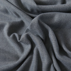 Detailed macro view of charcoal blue cashmere-like fabric showing soft twill texture