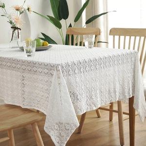 Nordic vintage white cotton lace tablecloth with hollow floral patterns on a wooden table