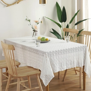 Nordic vintage white cotton lace tablecloth with floral patterns on a wooden table