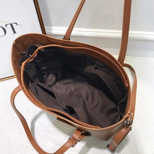 Brown faux leather tote bag with large capacity interior and internal pocket structure