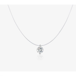 Macro detail of a single zircon pendant on a transparent fishing line silver necklace