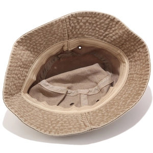 Inside view of khaki cotton bucket hat with sweatband, stitching, and metal eyelets