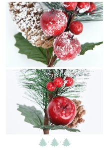 Macro detail of artificial Christmas pine branch with red berries, cones and faux snow