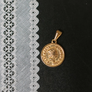 Detailaufnahme des 18K vergoldeten Elisabeth II. Münzanhängers auf schwarzem Grund