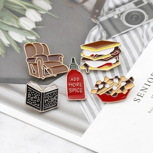 Set of 5 cartoon enamel pins featuring sandwich, fries, sauce, sofa and book designs