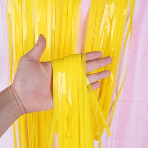 Close-up of yellow plastic fringe curtain for party backdrop decoration with soft texture