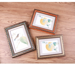 Detailed view of ornate European vintage photo frames with embossed floral relief patterns