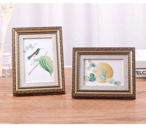 Close-up of vintage European photo frames with ornate embossed floral patterns and gold edges