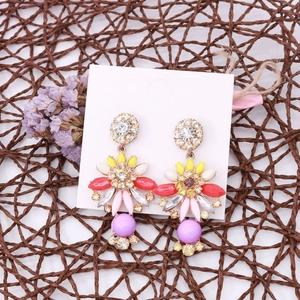 Detail view of Bohemian colorful flower earrings displayed on a white jewelry card
