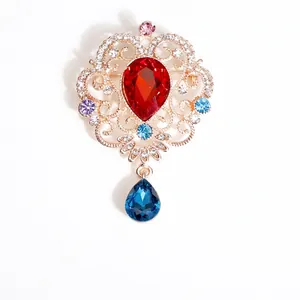 Baroque gold brooch with red teardrop crystal and blue pendant in vintage floral design