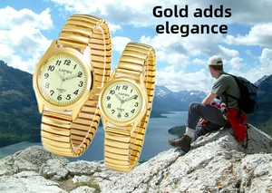 Close-up of golden couple watches with stretch bands and luminous dials for seniors
