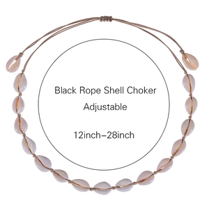 Handmade bohemian natural shell choker with adjustable black cord on a white background
