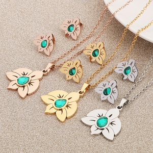 Floral stainless steel jewelry sets with green crystals in rose gold, gold, and silver