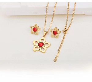 Detailed view of hollow five-petal gold flower jewelry set with red crystal stones