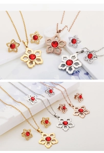 Detailed macro of hollow heart-petal flower jewelry set with ruby red crystal stones