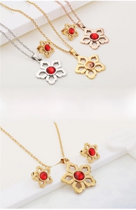Three colors of floral jewelry sets with red ruby crystals in gold, silver and rose gold