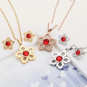 Floral jewelry set with ruby red crystals in gold, rose gold, and silver finishes
