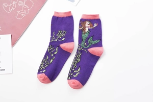 Detailed knit texture of purple cotton socks featuring pink accents and mermaid pattern