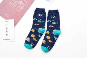 Detail of navy cotton crew socks with colorful tropical fish pattern and blue toe accents