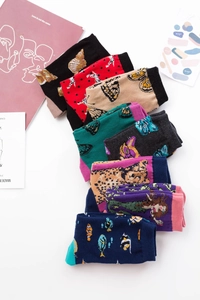 Flat lay of colorful mid-calf cotton socks with diverse animal and nature prints