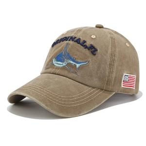 Detail of shark embroidery and American flag patch on washed cotton baseball cap