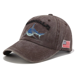 Detail of washed brown denim baseball cap with shark embroidery and US flag patch