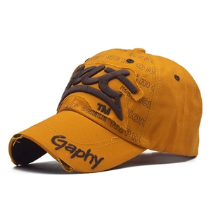Detail of mustard yellow distressed baseball cap featuring vintage 3D embroidery and rips