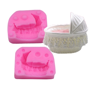 Detail showing pink silicone baby cradle mold set with white lace patterned cake topper