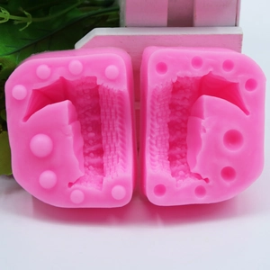 Detail view of pink plunger cutters for embossing letter and number shapes in fondant
