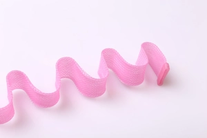 Detail of pink mesh heatless hair rollers with wave shape and secure plastic clips