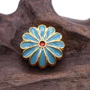 Exquisite golden sunflower charm with sky blue enamel petals and a red core center