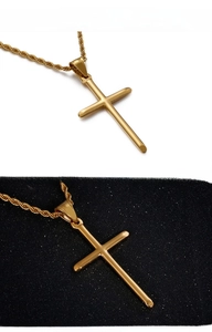 Polished gold cross pendant with rope chain on contrasting black and white backgrounds