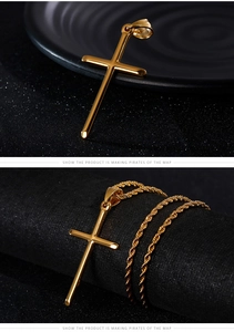 Detailed view of a gold cross pendant and twist chain on a dark textured surface