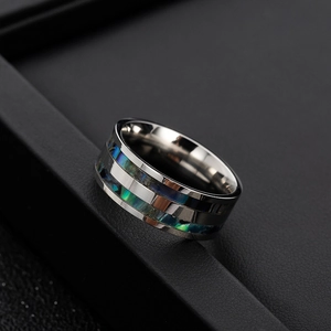 Titanium steel ring with inlaid iridescent abalone shell shown from a 45-degree angle
