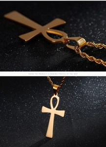 Macro detail of gold Ankh cross pendant with twisted rope chain on dark background