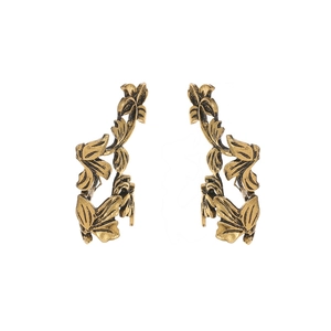 Detailed macro view of vintage gold hollow leaf ear cuffs with intricate vein textures