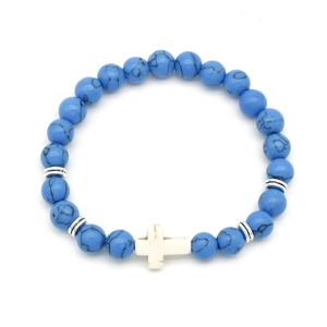 Detailed close-up of blue turquoise beaded bracelet with white cross charm and silver spacers