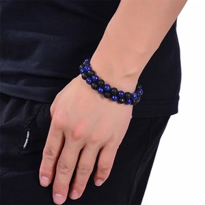 Detail shot of double-layer woven bracelet with blue lapis and black lava stone beads