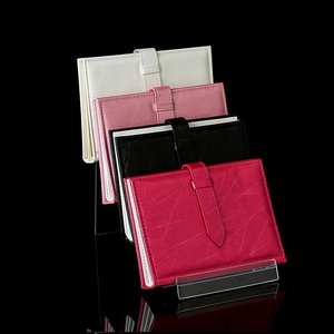Clear acrylic tiered display stand showcasing colorful leather wallets and passport holders