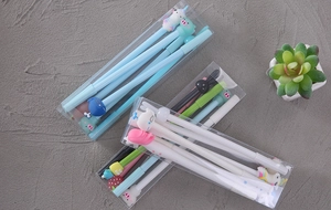 Assorted cartoon gel pens in boxes featuring animal designs on a gray background
