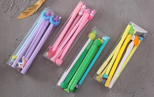 Set of cute cartoon gel pens with unicorn and pineapple designs in clear plastic cases