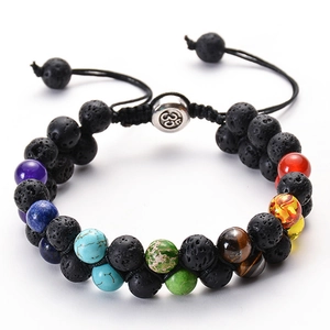 Detail of double-layer lava stone chakra bracelet with adjustable woven cord and Om bead