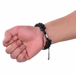 Close-up of double-layer natural tiger eye and lava stone beaded bracelet on wrist